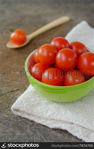 cherry tomato. Red cherry tomatoes on a textured wooden background