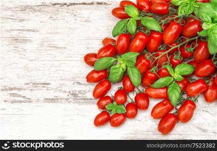 Cherry tomatoes and basil leaves. Food background