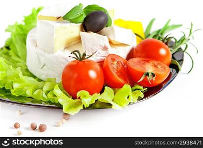 Cherry tomatoes and cheese on a wooden plate