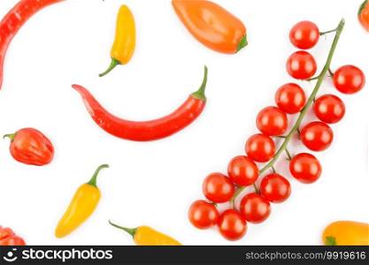 Cherry tomatoes, cayenne and chili pepper isolated on a white background. Colorful background. View from above.