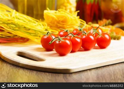 Cherry tomatoes. Cherry tomatoes and vegetables on kitchen table