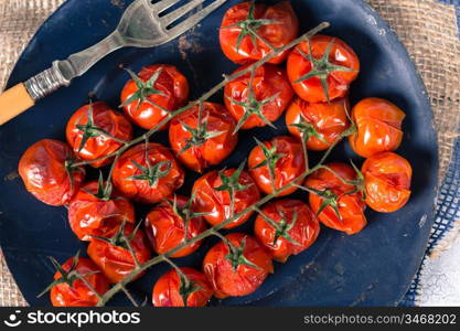 Cherry tomatoes cooked in the oven on the table