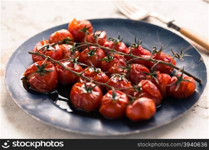Cherry tomatoes cooked in the oven on the table