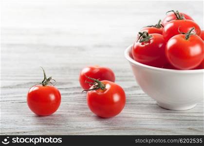Cherry tomatoes in white dish on a wooden table