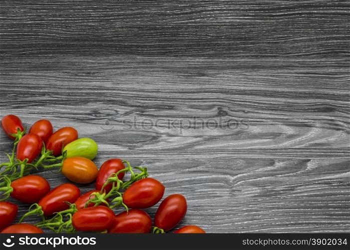Cherry tomatoes on a gray wooden table.