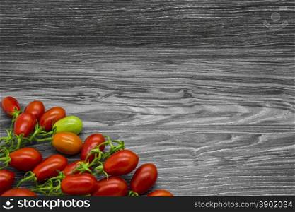 Cherry tomatoes on a gray wooden table.