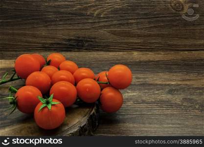 Cherry tomatoes on a wooden rustic background.