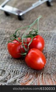 Cherry tomatoes over rustic background, selective focus
