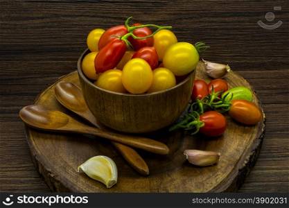 Cherry tomatoes still life on a wooden background.