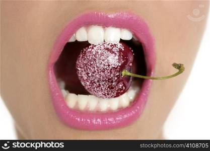Cherry with sugar between woman perfect teeth macro