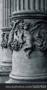 Cherub detail on old architectural pillar.