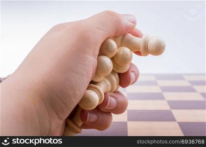 Chess board with chess pieces in the hand