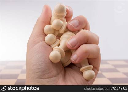 Chess board with chess pieces in the hand