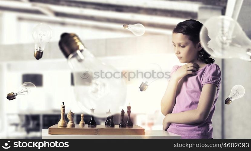 Chess game for clever mind. Young caucasian kid girl playing game of chess