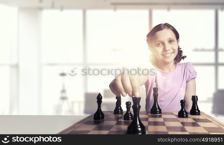 Chess game for clever mind. Young caucasian kid girl playing game of chess