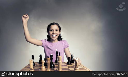 Chess game for clever mind. Young caucasian kid girl playing game of chess