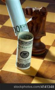 chess with dollar and euro banknote. symbol for the dollar&acute;s depreciation against the euro.