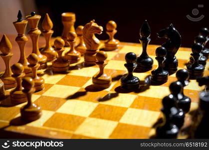 Chessboard with figures on dark background