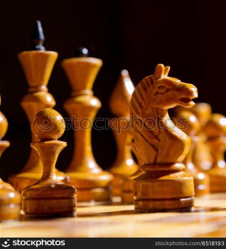 Chessboard with figures on dark background