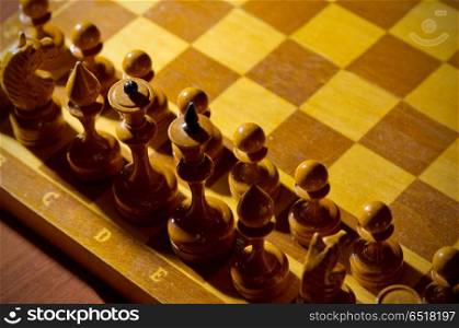 Chessboard with figures on dark background