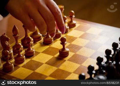 Chessboard with figures on dark background