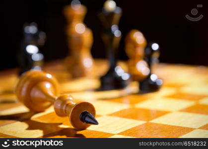 Chessboard with figures on dark background