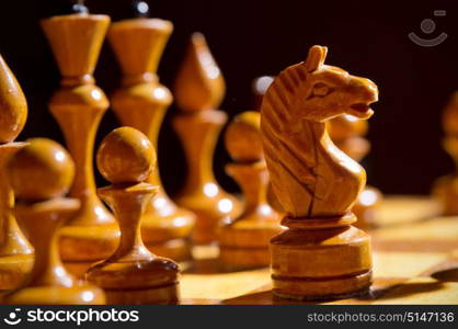 Chessboard with figures on dark background. Chessboard with figures