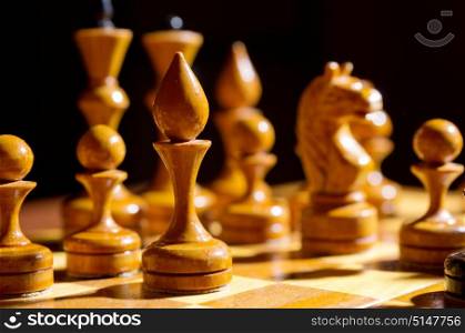 Chessboard with figures on dark background. Chessboard with figures