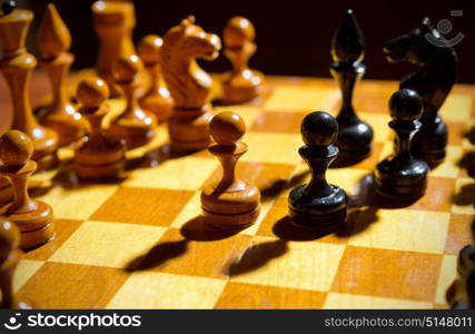 Chessboard with figures on dark background. Chessboard with figures