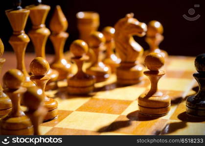 Chessboard with figures on dark background. Chessboard with figures