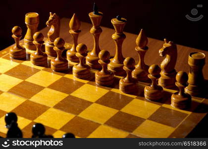 Chessboard with figures on dark background. Chessboard with figures