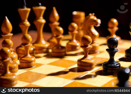 Chessboard with figures on dark background. Chessboard with figures on dark