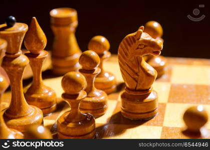 Chessboard with figures on dark background. Chessboard with figures on dark