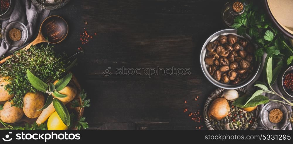 Chestnuts cooking ingredients on dark rustic background, top view, place for text. Seasonal food and eating. Banner