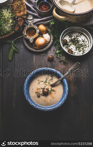 Chestnuts creamy soup bowl on dark rustic kitchen table background , top view. Seasonal food and eating