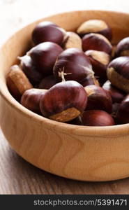 Chestnuts in wooden plate on talbe