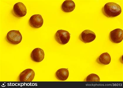 Chestnuts pattern on yellow background, top view, chestnut, castanea