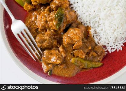 Chettinadu traditional Indian chicken bone-in curry, served with white rice, high angle