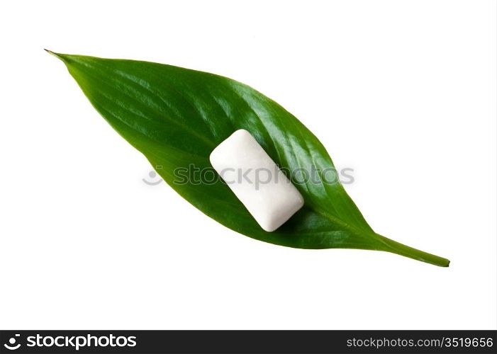 chewing gum on a green leaf isolated on a white background