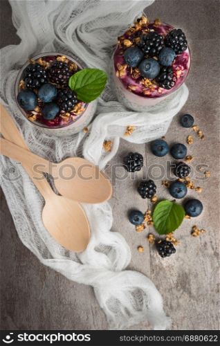 Chia pudding parfait with blackberries and blueberry smoothie and granola.