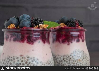 Chia pudding parfait with blackberries and blueberry smoothie and granola.