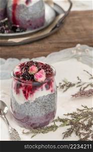 Chia pudding with blackberries and jam in glass jars. Concept of healthy eating, healthy lifestyle, dieting, fitness menu