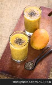 Chia seed (lat. Salvia hispanica) and mango juice photographed with natural light. Chia seeds are considered a superfood containing proteins, omega fats, minerals and antioxidants (Selective Focus, Focus on the chia seeds on the drink)