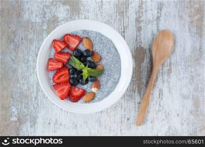 chia seed pudding on a white wood background