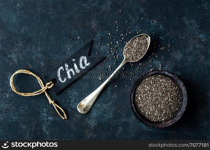 Chia seeds in a stone bowl on a dark background