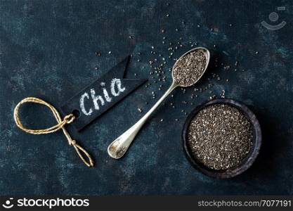 Chia seeds in a stone bowl on a dark background