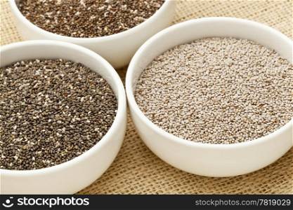 chia seeds in white ceramic bowls - three varieties including white chia