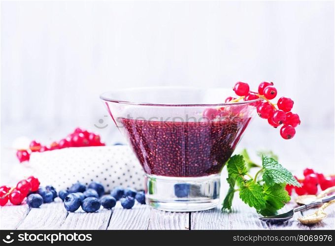 chia smoothie with fresh berries in glass and on a table