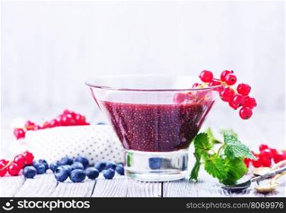 chia smoothie with fresh berries in glass and on a table
