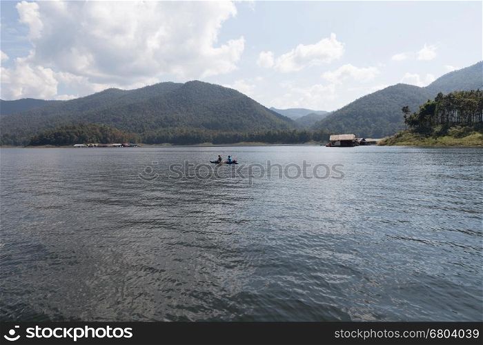 Chiang Mai, Thailand - December 27, 2016: Tourists kayaking on lake in the mountains at Mae Ngad Dam and Reservoir in Chiang Mai, Thailand on December 27, 2016